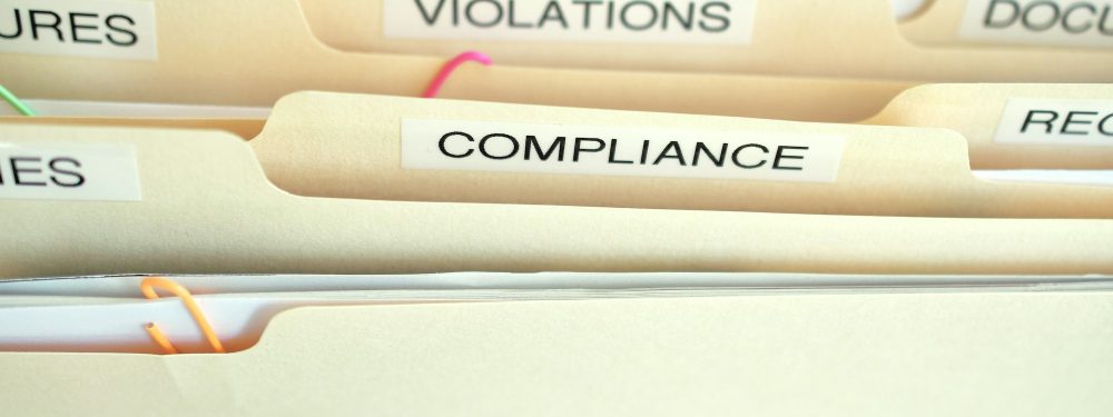 Compliance in the workplace. Folders labeled Compliance, Violations in focus.